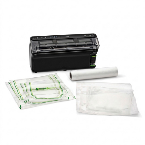 FoodSaver Elite All-in-One Liquid+ Vacuum Sealer, Bags, and Roll isolated on white.