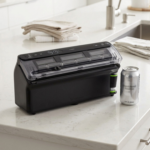 The FoodSaver Elite All-in-One is shown on a kitchen island, with a soda can providing scale.
