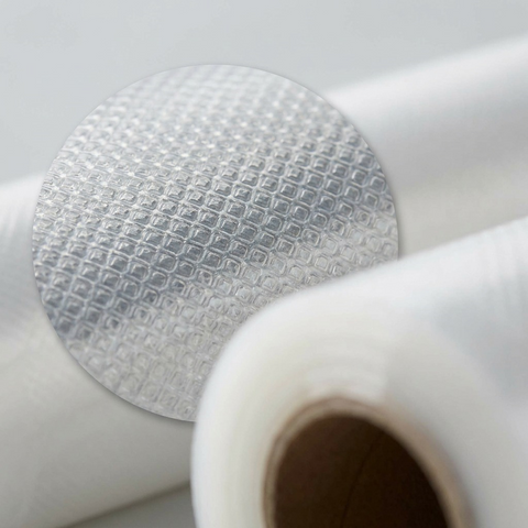 An extreme close-up view focusing on the embossed, textured mesh pattern on a clear, food-grade plastic vacuum sealer bag from the VSB2CNW 2-pack. The photo shows the regular pattern for air removal.